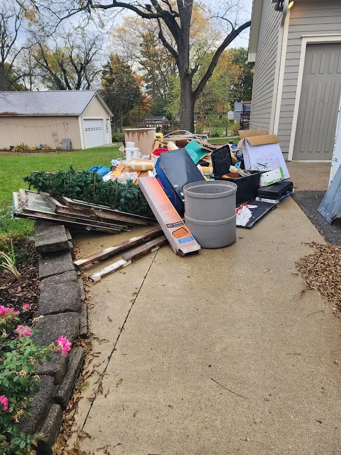 Dumpster being loaded with debris for Residential Dumpster Rental in Wake Forest
